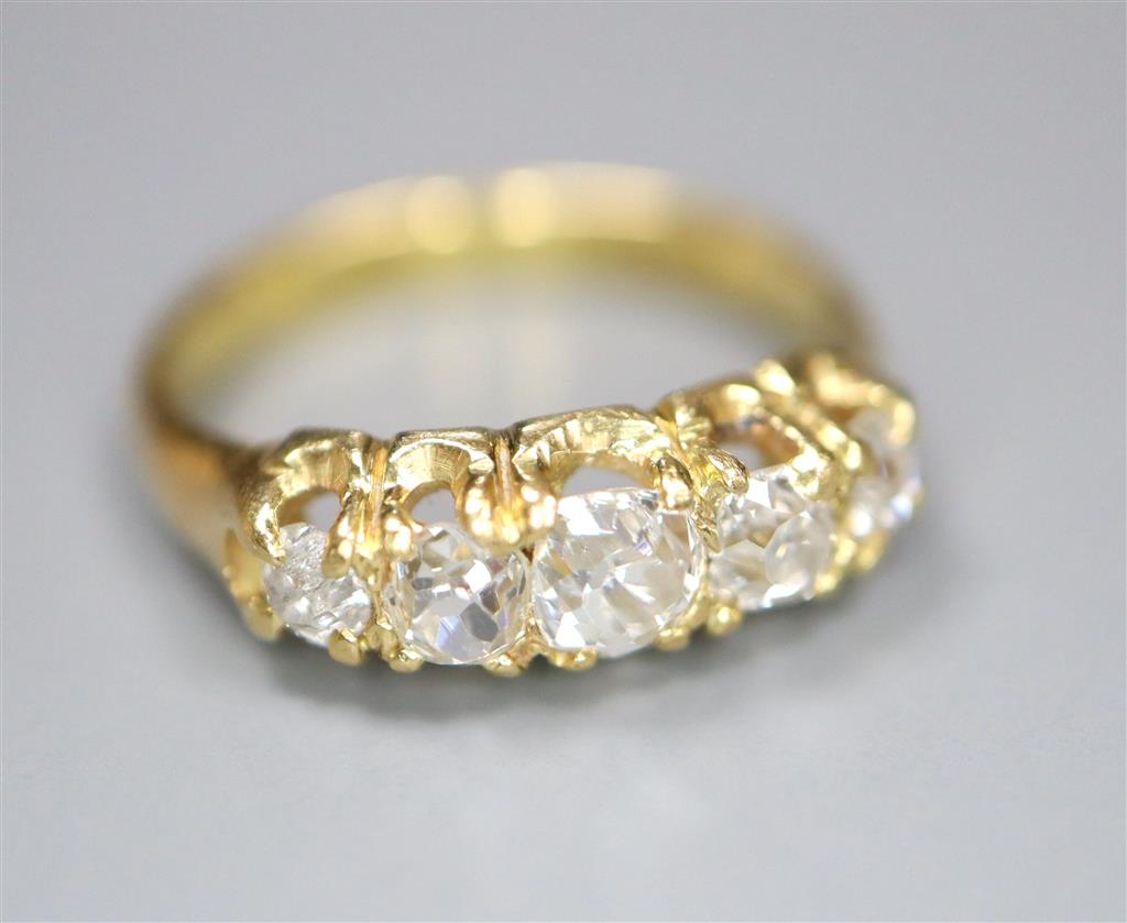 An 18ct and graduated five stone old cut diamond set childs ring, size E/F, gross 2.5 grams.